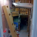 One piece of benchwork for the staging yard and pipes secured in the utility room